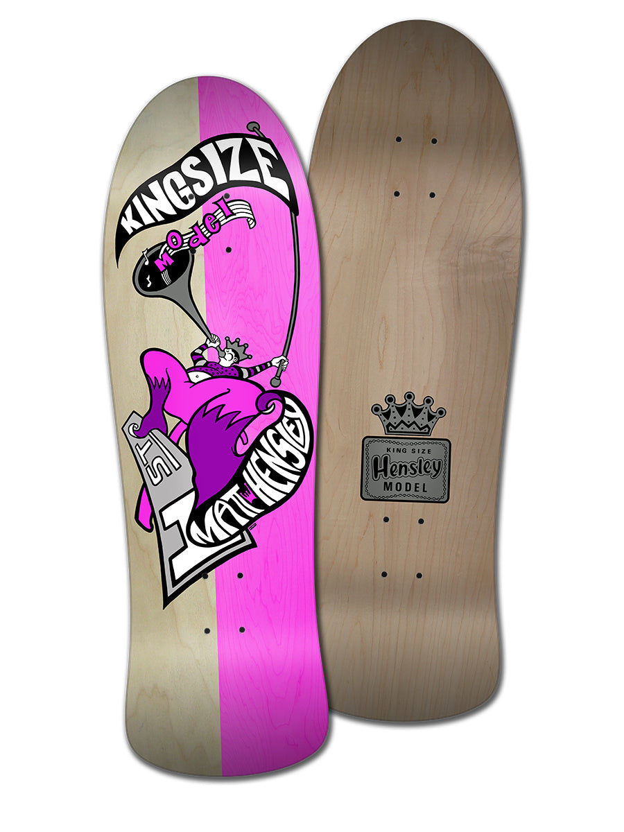 Two skateboard decks: one split pink/natural wood with a purple cartoon monkey holding a scepter and wearing a crown, and another plain wood Legend Skates MATT HENSLEY KINGSIZE HORNBLOWER G SERIES deck with the classic “Hensley Model” crown graphic.