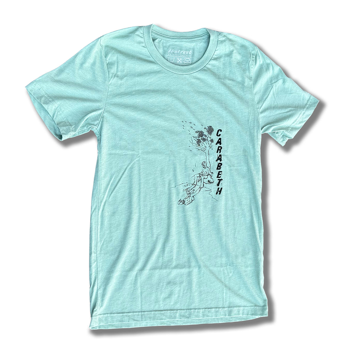The CARABETH TREE OF LIFE T-SHIRT by MH Printing is a light blue bi-blend tee with a black rock climber graphic and "CARABETH" printed vertically. Made in California for style and comfort.