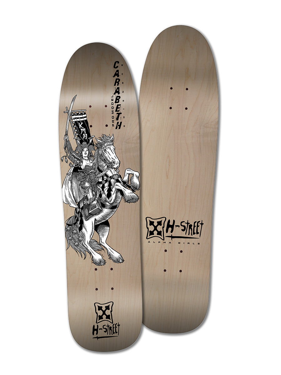 Two Woodchuck CARABETH WARRIOR skateboard decks are shown. One displays a black-and-white illustration of CaraBeth Burnside as a knight with "CARABETH!" above, both honoring girls skateboarding legends.