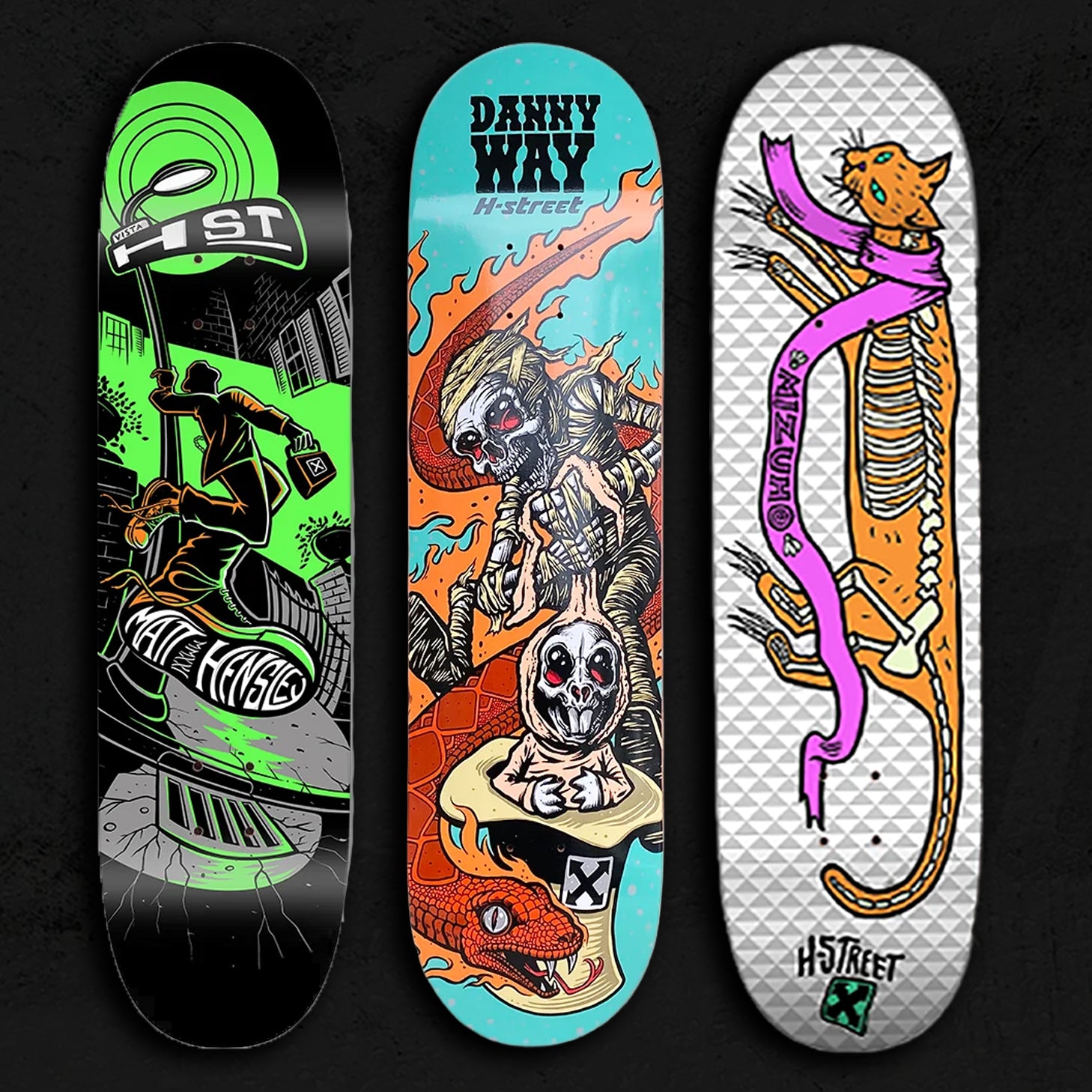 Three illustrated skateboard decks on a textured dark grey background.