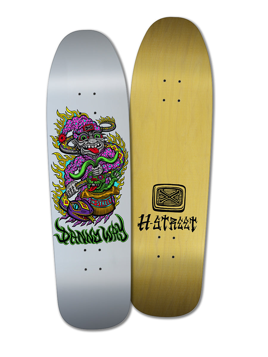 Two Woodchuck decks: the D-WAY/DYER SE features a colorful cartoon monster breathing fire on silver, inspired by spiritual skate graphics; the RABBIT IN THE HAT is plain wood with a black “Hatchet” text graphic.