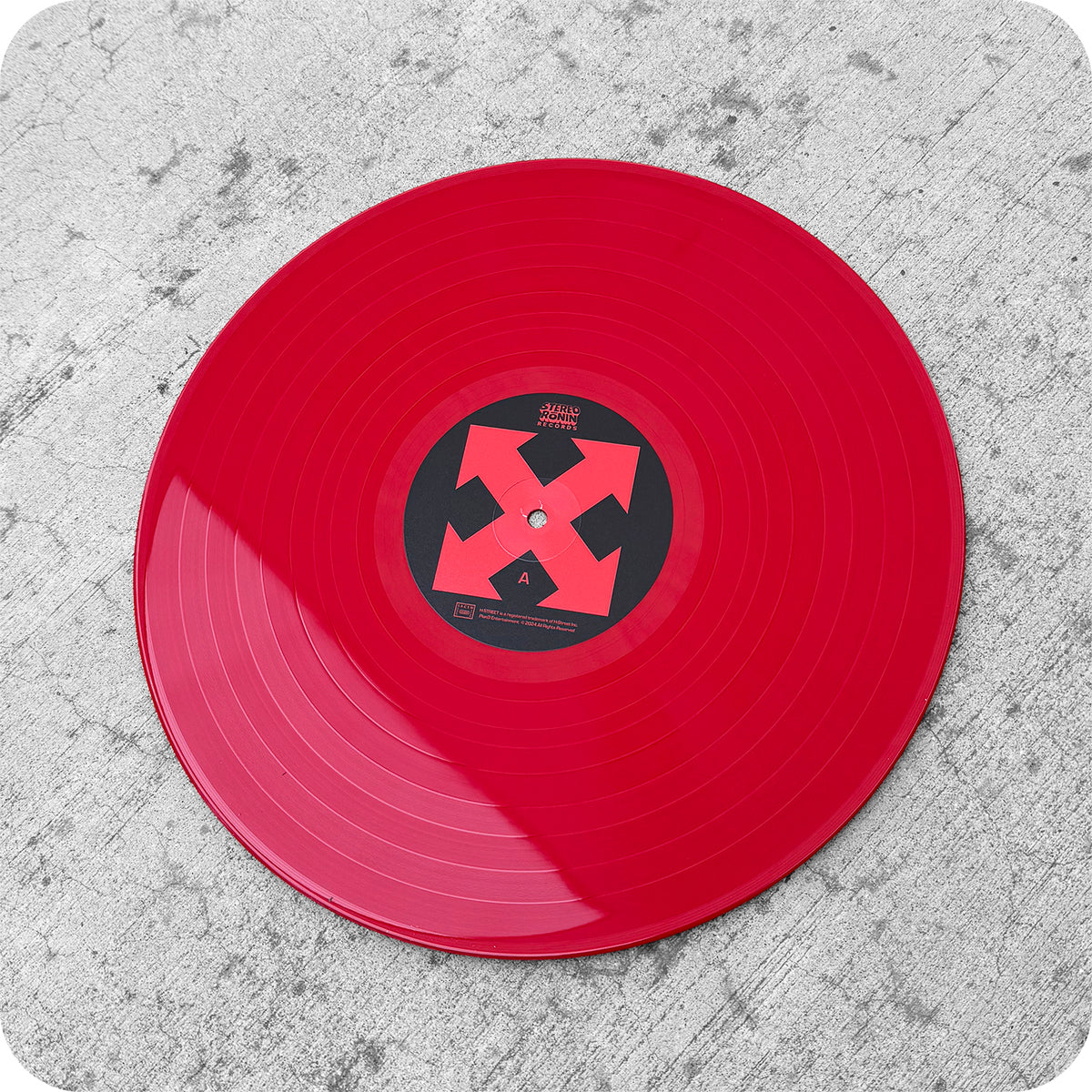 A red H-STREET VINYL SOUNDTRACK by STEREO RONIN, with a bold X black and red label, rests on textured gray concrete—celebrating the iconic skateboarding soundtrack’s special 35th anniversary edition.