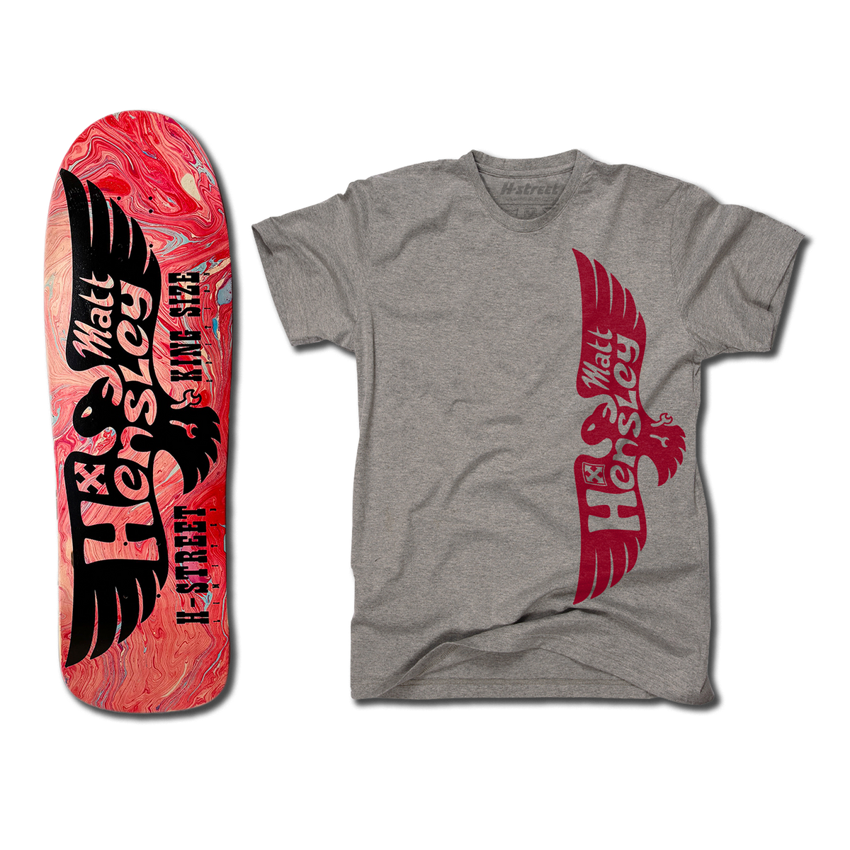 The bottom of a Hensley Eagle King Size Skateboard deck. The bottom is hydro dipped with a black eagle. Next to it is a grey shirt with the red eagle logo on the front.