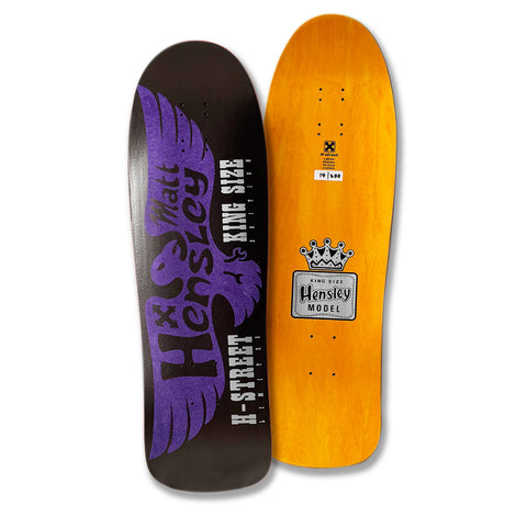 Two skateboard decks, one with a purple and black eagle silhouette design featuring the text 'Matt Hensley' and 'King Size', and the other with an orange background and a label that reads 'King Size Hensley Model' with a crown.