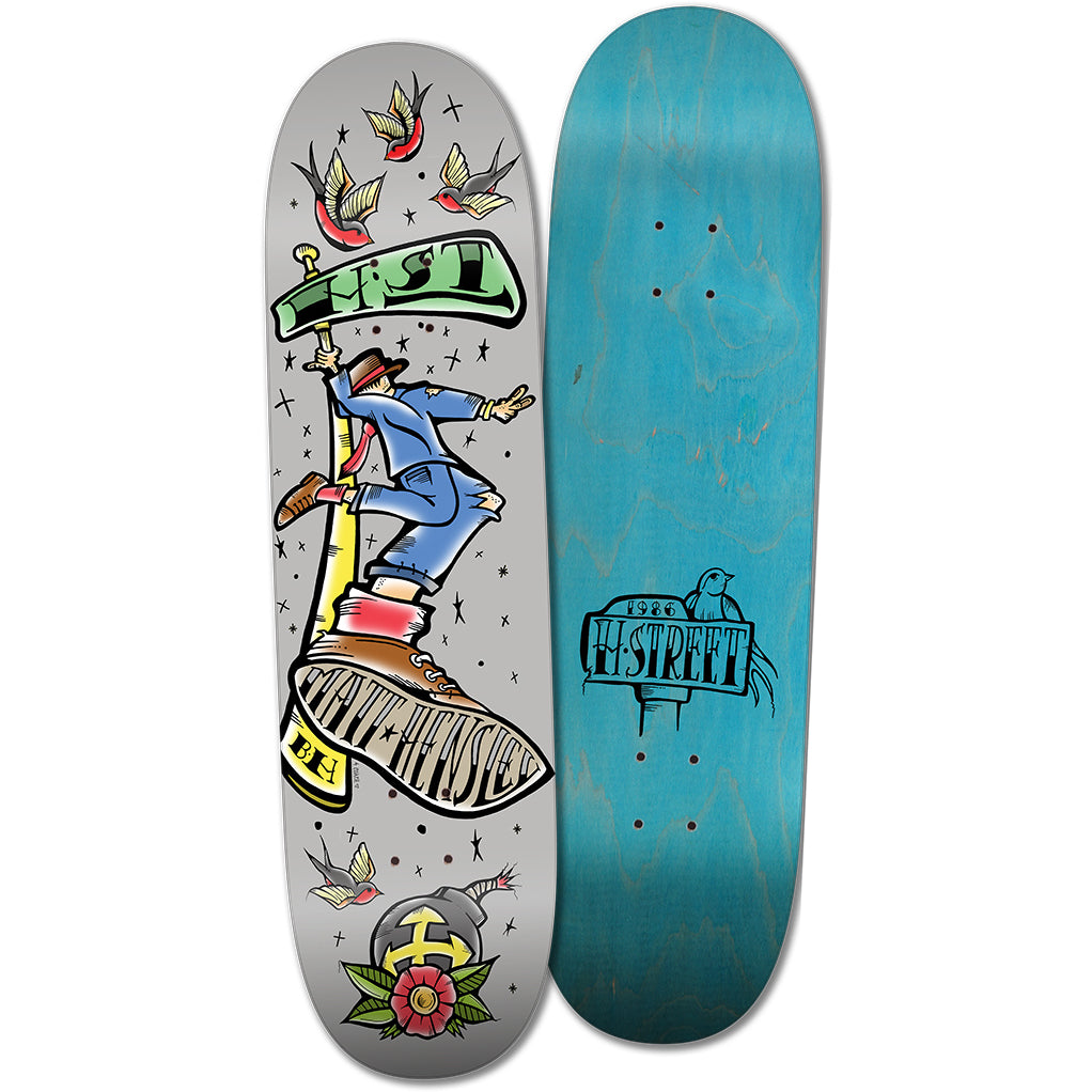 Two hard rock maple decks by Woodchuck: the blue wood grain Matt Hensley Street Swinger with H-STREET logo, and THE HENSLEY SAILOR JERRY TATTOO STREET SWINGER featuring a suit-clad skater with birds, stars, and a rose with an anchor.