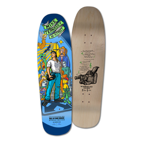 A special edition commemorative skateboarding deck featuring artwork with a man and various skateboarding elements, with a predominantly blue background on one side, and a graphic of a skateboard with the text 'HALL OF FAME' on the natural color of the skateboard on the other side.