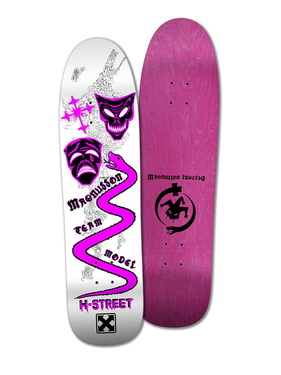 Two Woodchuck skateboards side by side: one is the T-MAG MASKS & SERPENT deck with white faces, purple zigzag, and Magnusson Designs text; the other has a bold black logo on a solid magenta finish.