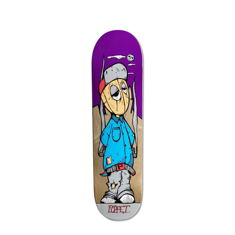 A skateboard deck with a puppet character on a purple and wood grain background with the words 'Puppet'.