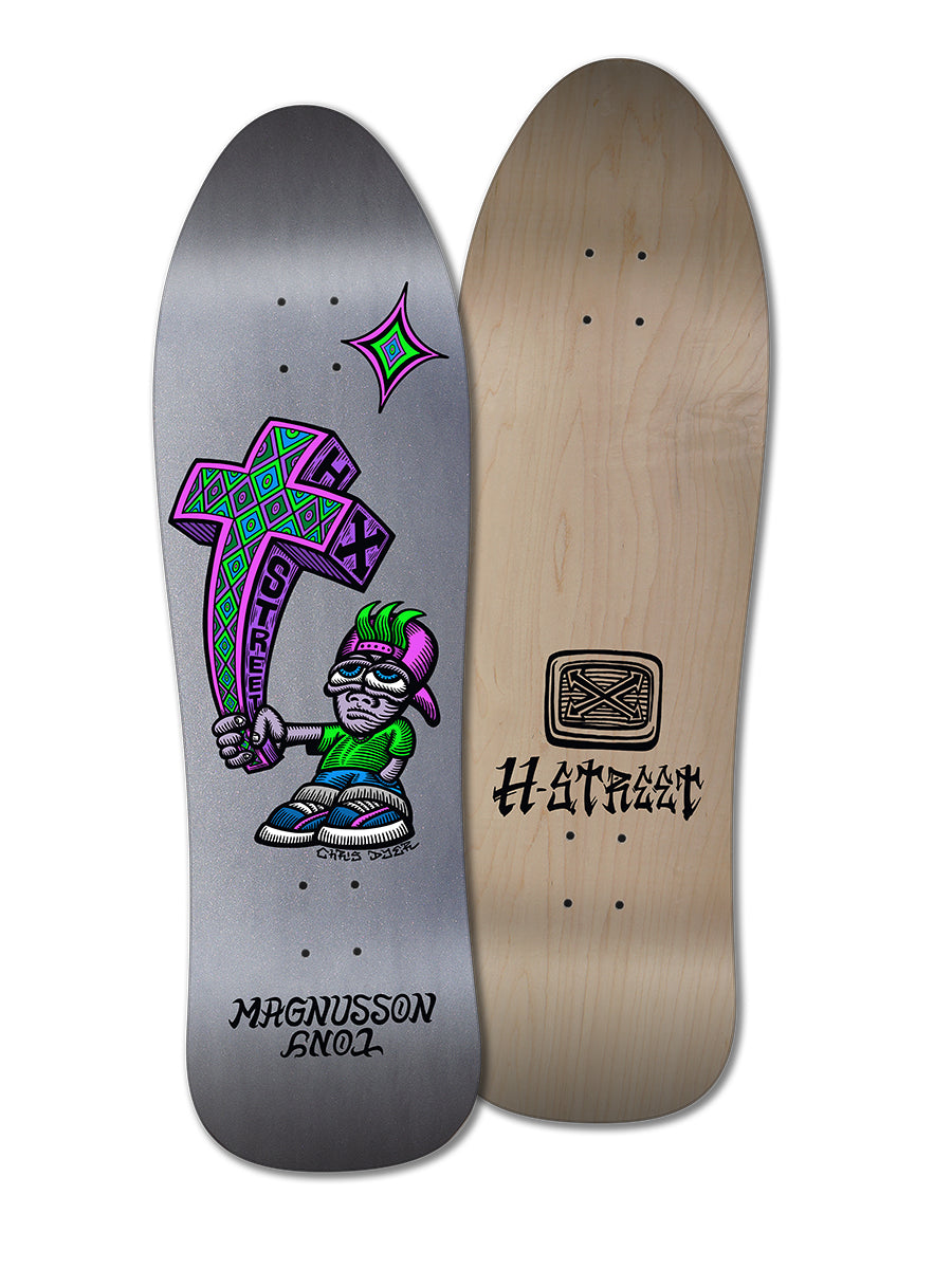 Two skateboard decks by Woodchuck: the T-MAG/DYER SE, KID'N'CROSS features Chris Dyer’s cartoon character holding a large cross with "STREET" in purple-green; the other is plain wood with bold black text—ideal for graphic deck fans.