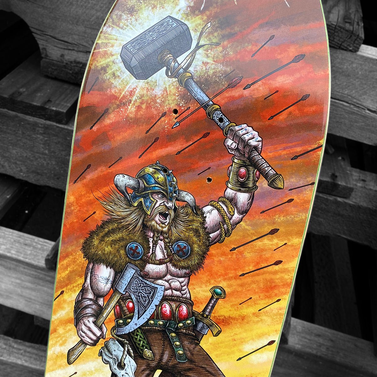 Experience the Woodchuck PER VIKING MEMORIAL SERIES skateboard deck, showcasing a fierce Viking warrior with a horned helmet and hammer amid lightning—an epic tribute to Per Viking and Vällingby’s skateboarding culture.