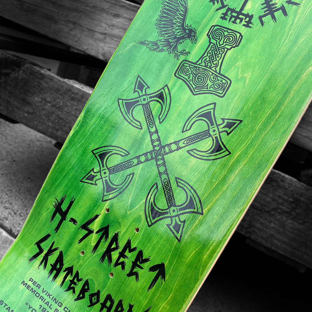 The Woodchuck PER VIKING MEMORIAL SERIES deck features Norse-inspired black art—crossed axes, a Viking hammer, and an eagle—on green, honoring Per Viking and his Vällingby roots.