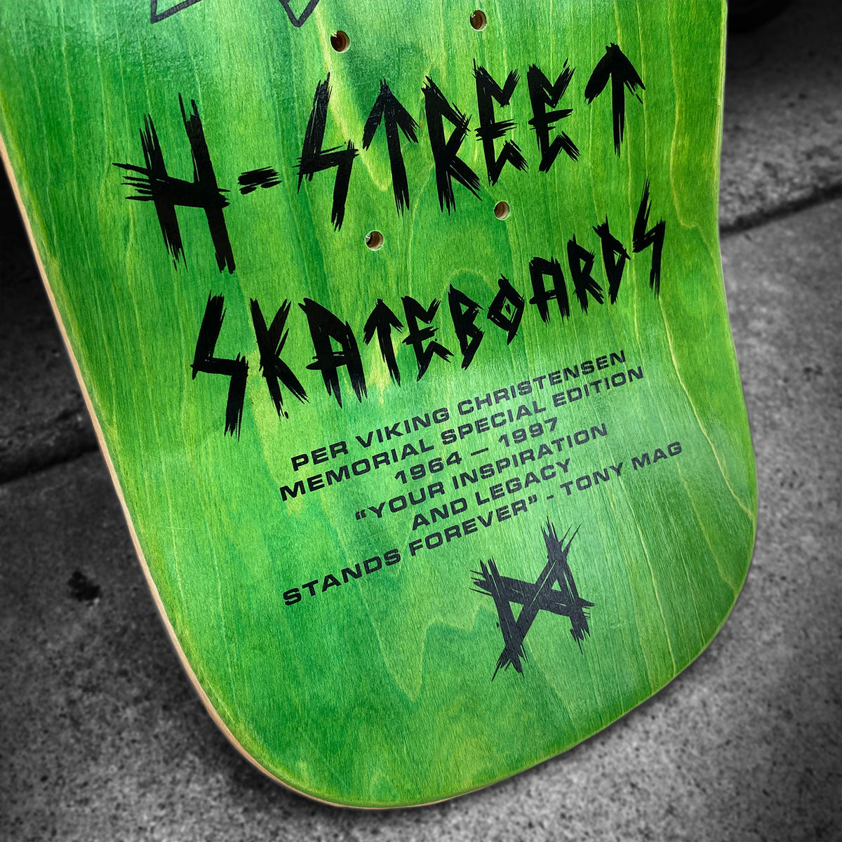 A green skateboard deck by Woodchuck, PER VIKING MEMORIAL SERIES, features black "H-Street Skateboards" text and the dedication: Per Viking Christensen Memorial Special Edition 1966-1987, honoring his legacy and inspiration from Vällingby.