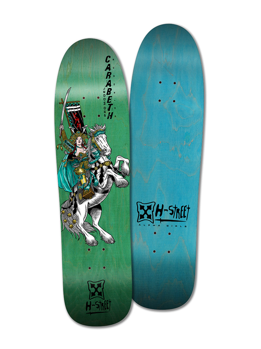 Two skateboard decks: on the left, the green "CARABETH WARRIOR" by Woodchuck shows a skateboarding girl as a warrior woman on a white horse; on the right, a blue deck with the classic H-Street logo.