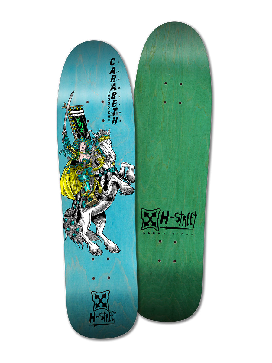 Two skateboards: one with green wood grain, the other—the Woodchuck CARABETH WARRIOR—shows girls skating and CaraBeth Burnside as a female warrior on horseback holding a banner, with Carabeth and H-Street logos on a blue background.