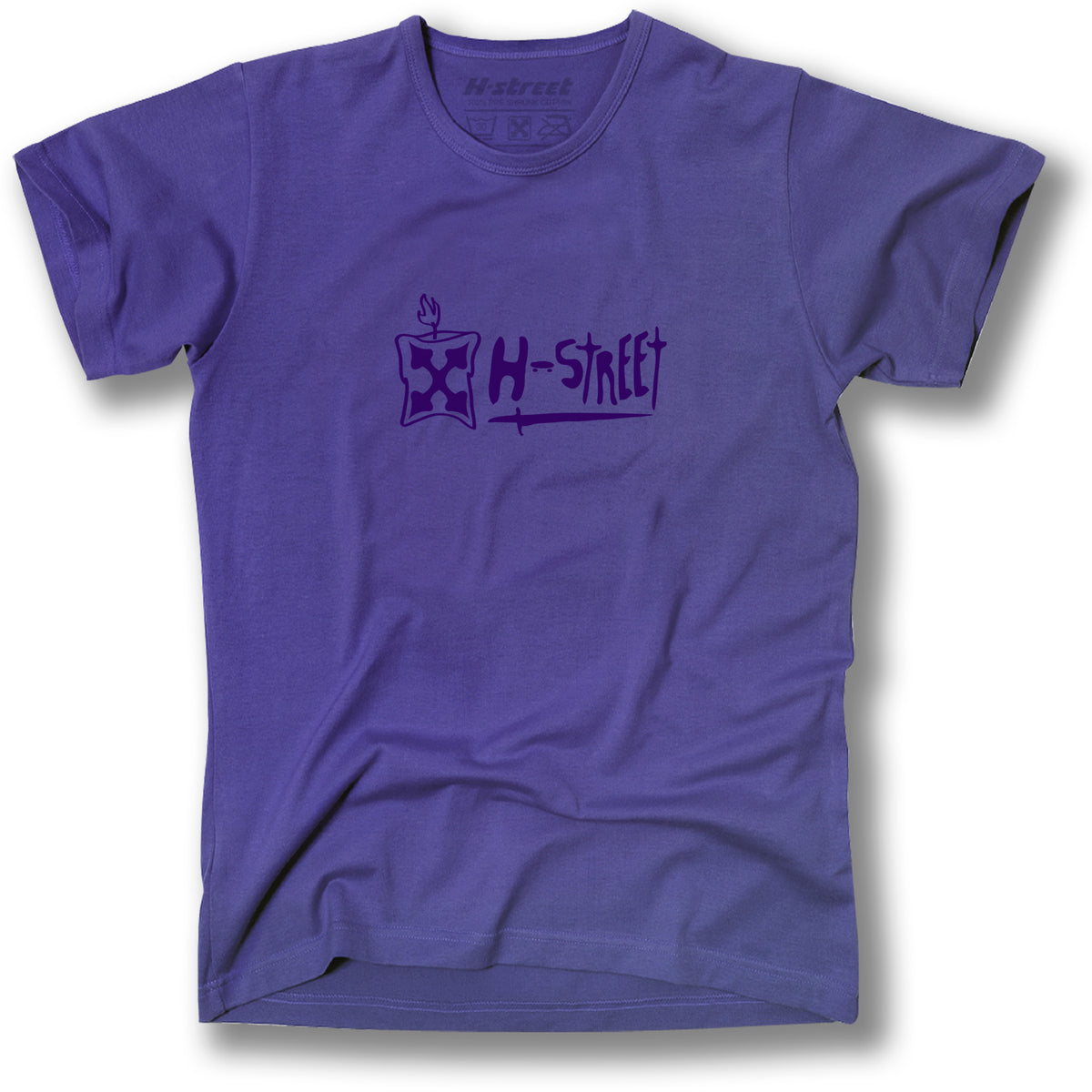 The Minuteman ADDISON SWORD LOGO T-SHIRT is a purple tee with a hand-drawn H-Street logo and small flame above a square on the chest, inspired by Addison Taylor’s classic Sword logo style.