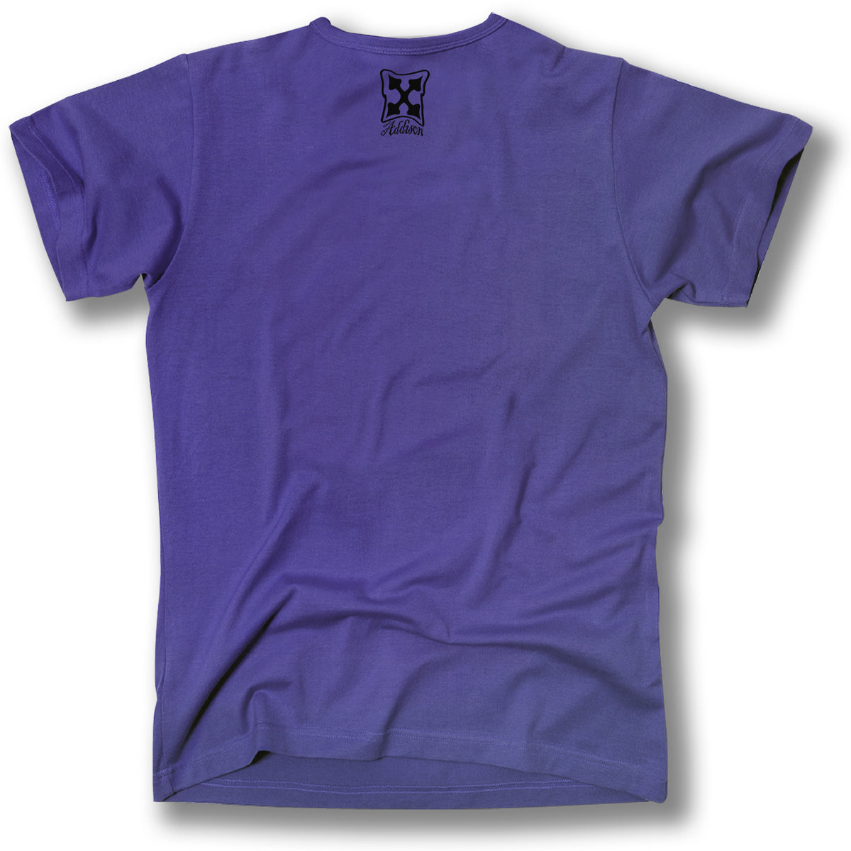 A purple Minuteman ADDISON TAYLOR DESIGN T-SHIRT, shown from the back, features a small black logo and "Aloha" near the neckline, highlighted with subtle Addison Taylor graphics for a unique style.
