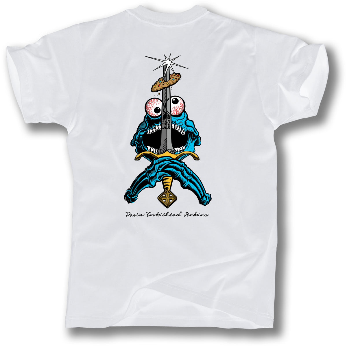 White t-shirt by Minuteman: SWORD AND COOKIE SKULL TEE, showcasing a vibrant cartoon monster wielding a sword piercing a donut, with “Dave Tourtelot Inkbers” below—a playful, Tim Baron-inspired design.