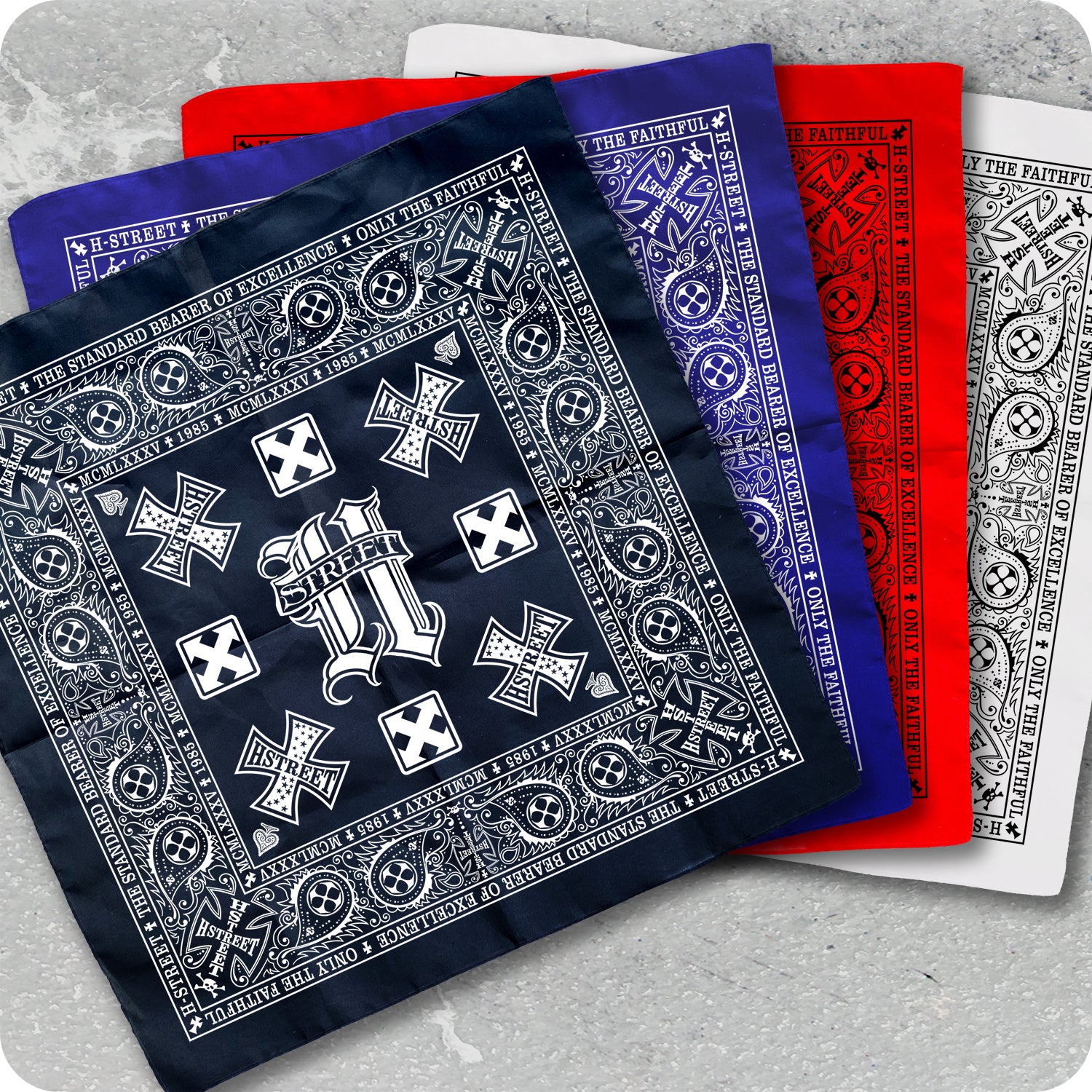 Three intricately patterned H-STREET ART BANDANAS by China Factory in navy blue, red, and white are layered on a gray surface. Each features ornate borders, crosses, and a large stylized S with "STREET" in the center.