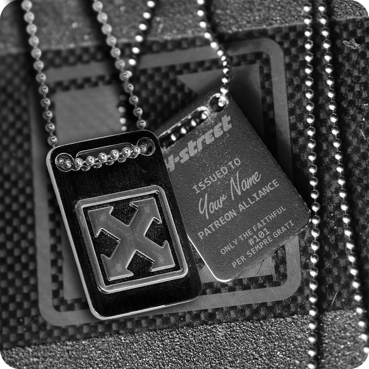 The H-STREET PATREON ALLIANCE DOG TAG by China Factory features two metallic tags on ball chains—one with the bold H-Street mark logo, the other custom engraved with "ISSUED TO Your Name" and "PATREON ALLIANCE.