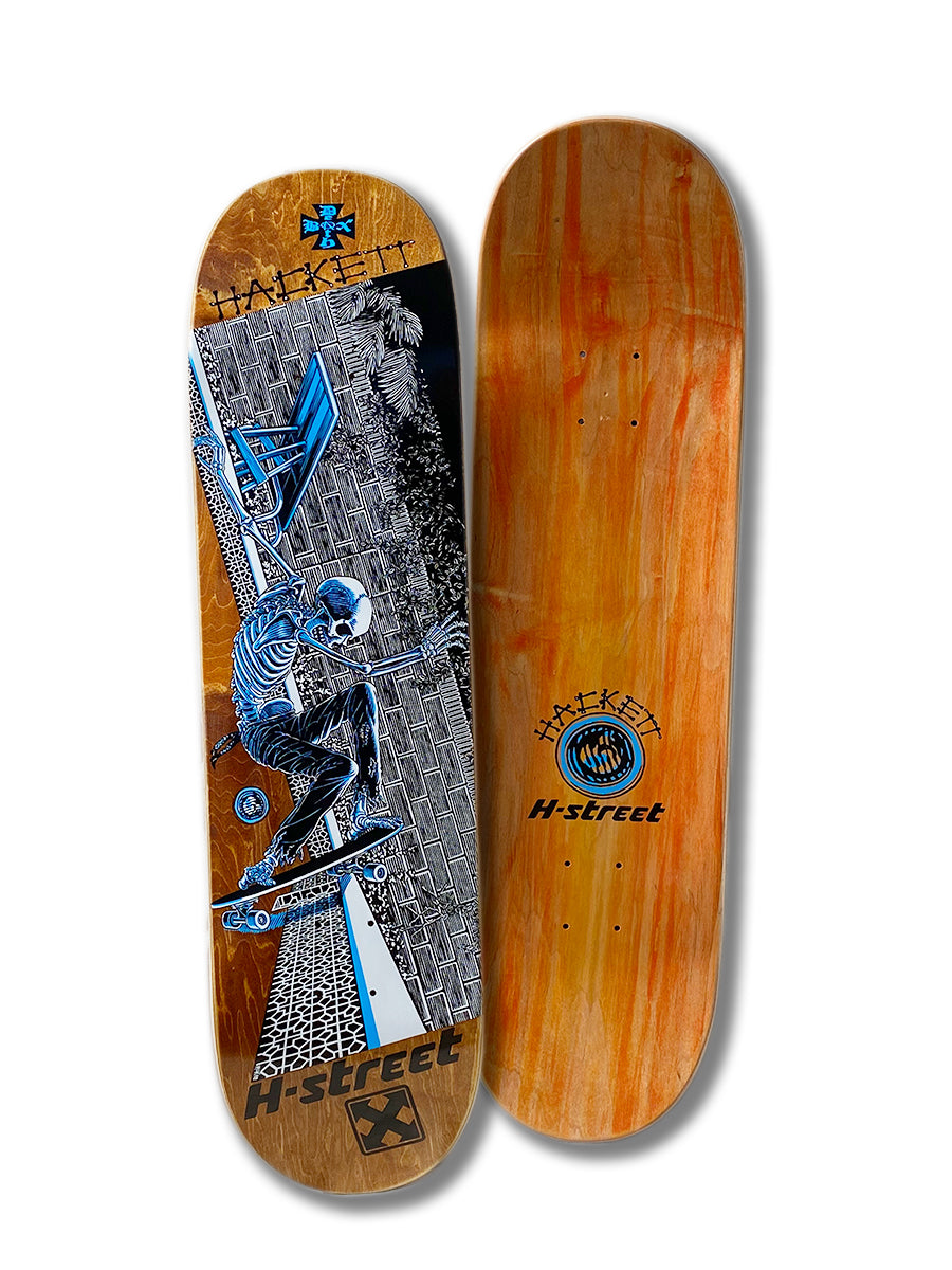 Two skateboard decks: on the left, the Perfect Skateboarding DAVE HACKETT SLASH STREET deck featuring Marc McKee’s skeleton artwork; on the right, a wood grain deck with H-Street/Deathbox branding and a blue logo.