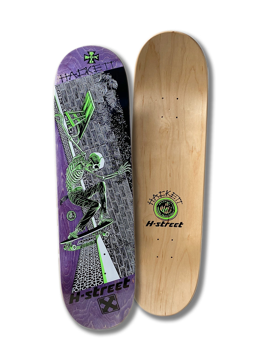Two Perfect Skateboarding DAVE HACKETT SLASH STREET decks: one with Marc McKee's skeleton skating by a green and purple brick wall, the other plain wood with “H-Street” and a green logo, displayed side by side.