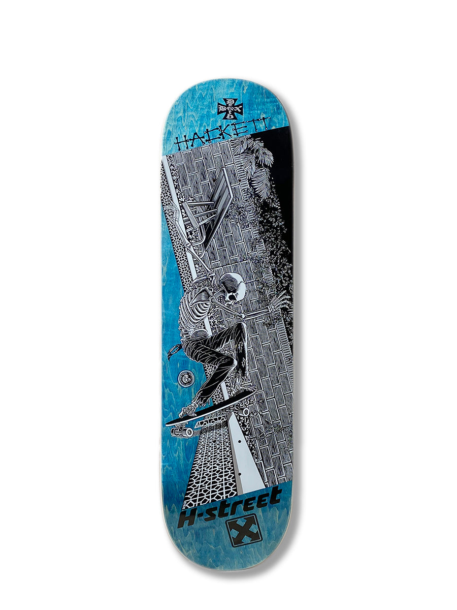 The Perfect Skateboarding DAVE HACKETT SLASH STREET deck has blue edges and black-and-white Marc McKee art showing a skateboarder near a brick wall, bench, and plants. “HACKETT” and “H-STREET” are also displayed on the deck.