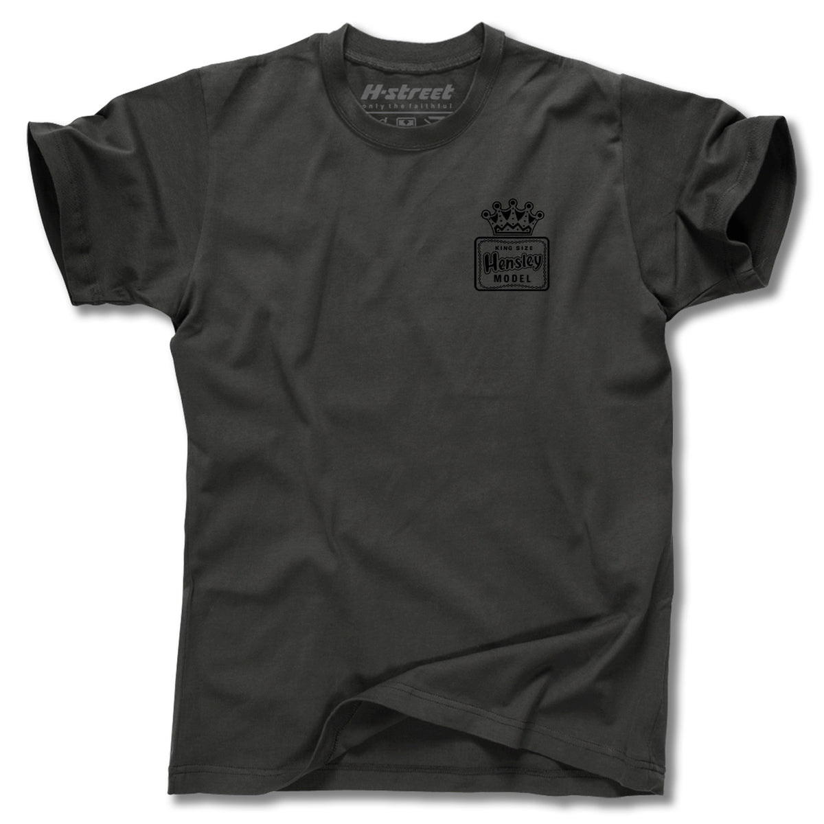 The Minuteman MATT HENSLEY KINGSIZE NEW EAGLE TEE is a plain black men’s t-shirt featuring a small crown graphic and H-street Hensley Model text on the left chest. Made in the USA, it’s shown laid flat with slight bottom folds.