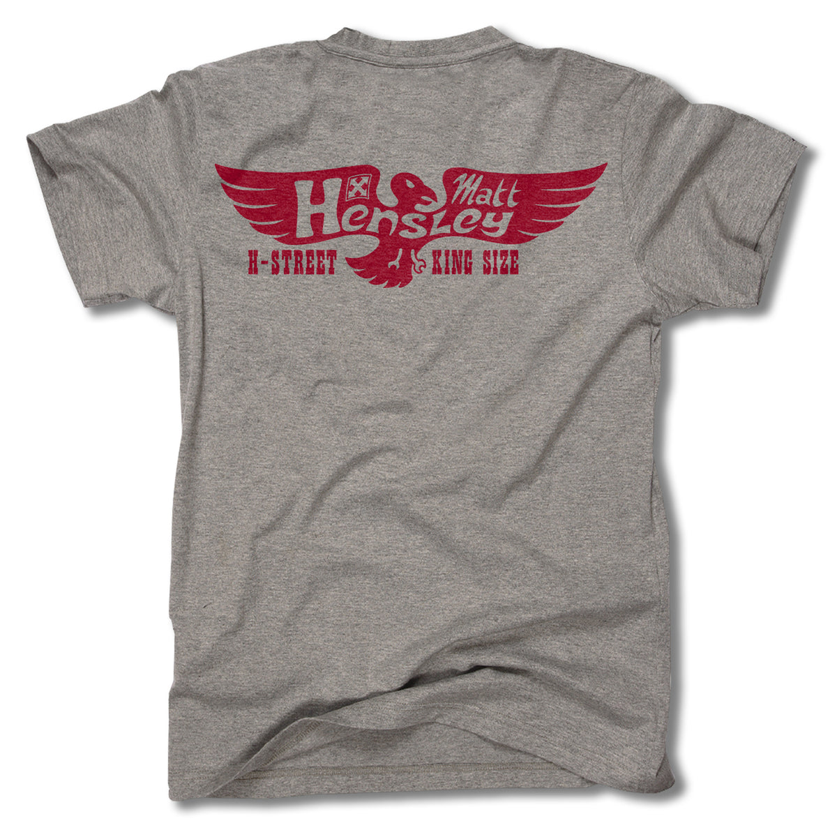 The MATT HENSLEY KINGSIZE NEW EAGLE TEE by Minuteman is a gray men’s t-shirt made in the USA, featuring a bold red eagle and wing graphic with “Hensley Matt” and “H-Street King Size” text on the back.