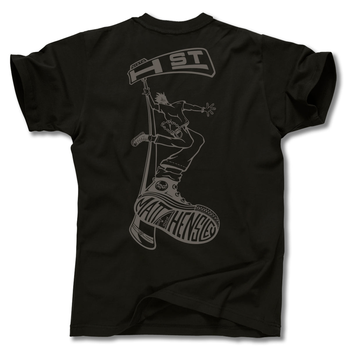 The MATT HENSLEY STREET SWINGER TEE by Minuteman is a black graphic tee with bold “MATHENY’S” on the shoe sole and a large back line art of a person jumping with a “1st” street sign, made in the USA.