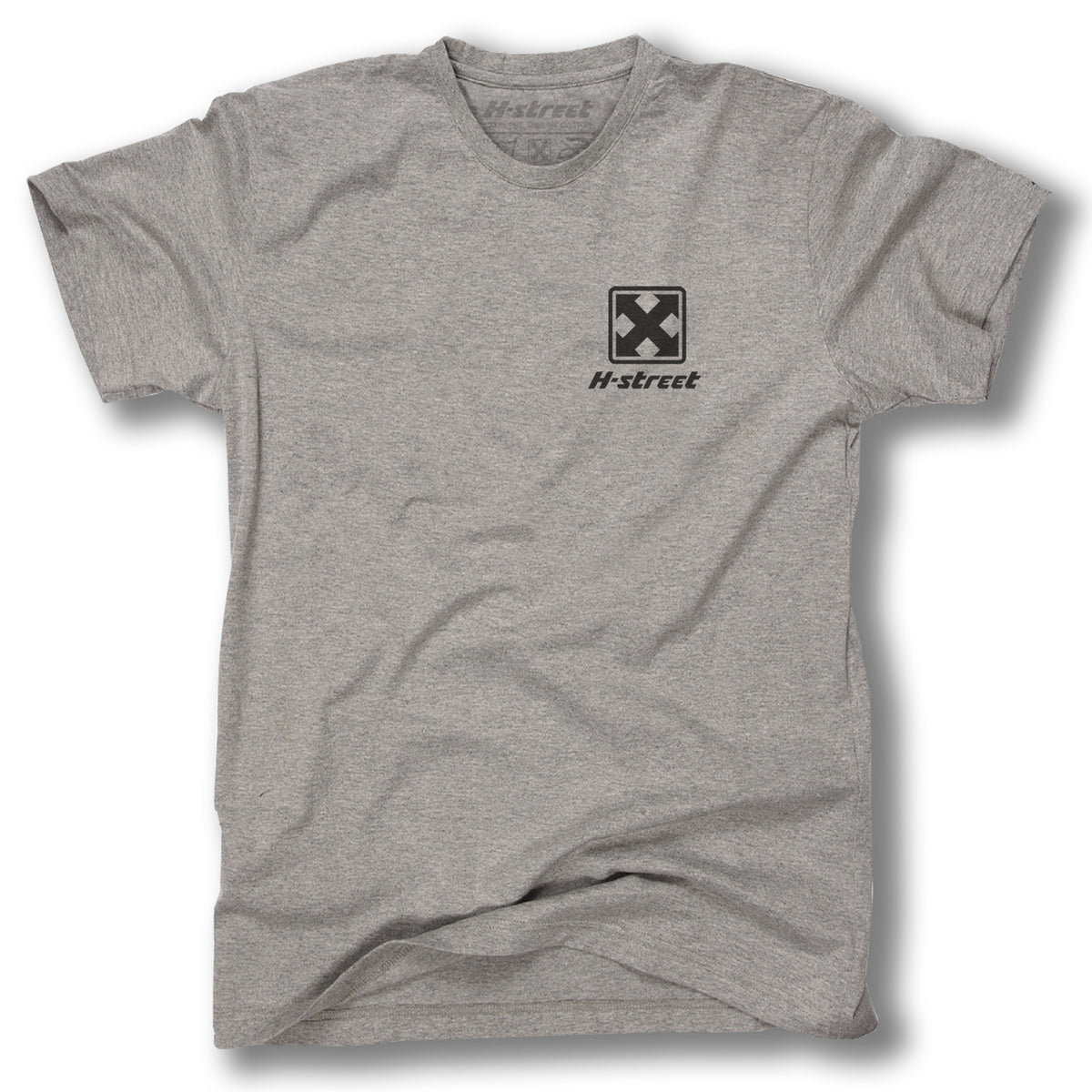 The Minuteman KIRK & THE JERKS SPECIAL EDITION TEE is a plain grey shirt with a small black X logo above “H-street” on the left chest, styled like vintage garage rock band merch and shown laid flat on a white background.