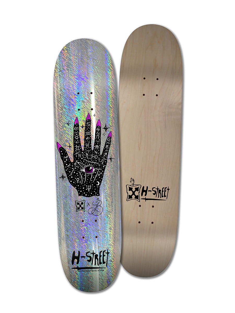 Two LOTUS PALM OF DESTINY skateboard decks by Perfect Skateboarding: one with Lotus Burnquist’s holographic black hand, mystical symbols, and pink nails art; the other features a wood finish with the H-Street logo—both exude Alpha Girls artistry.