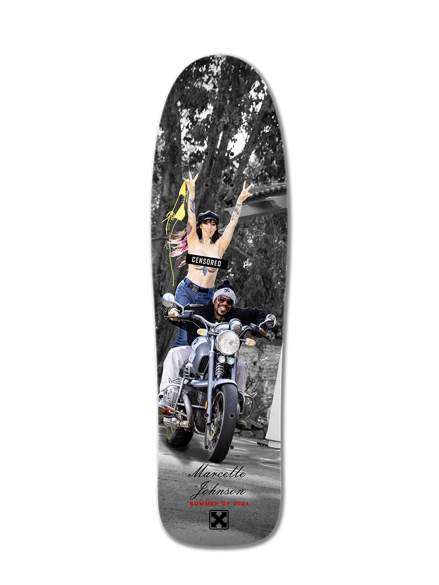 The MARCELLE JOHNSON LIBERTY skateboard deck from Starnet features a black-and-white photo of a man on a motorcycle and Marcelle Johnson in color, raising one arm in a CENSORED top. Sublimated slick bottom graphics complete the design.