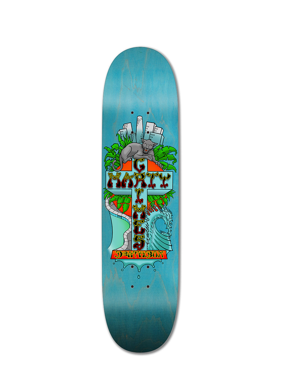 The MARTY GRIMES DEATHBOX POP SHAPE by Perfect Skateboarding is a blue deck with a vibrant graphic of a stone cross, green leaves, an armadillo, birds, and wave patterns—paying tribute to DogTown skating and the Z-Boys in Los Angeles.