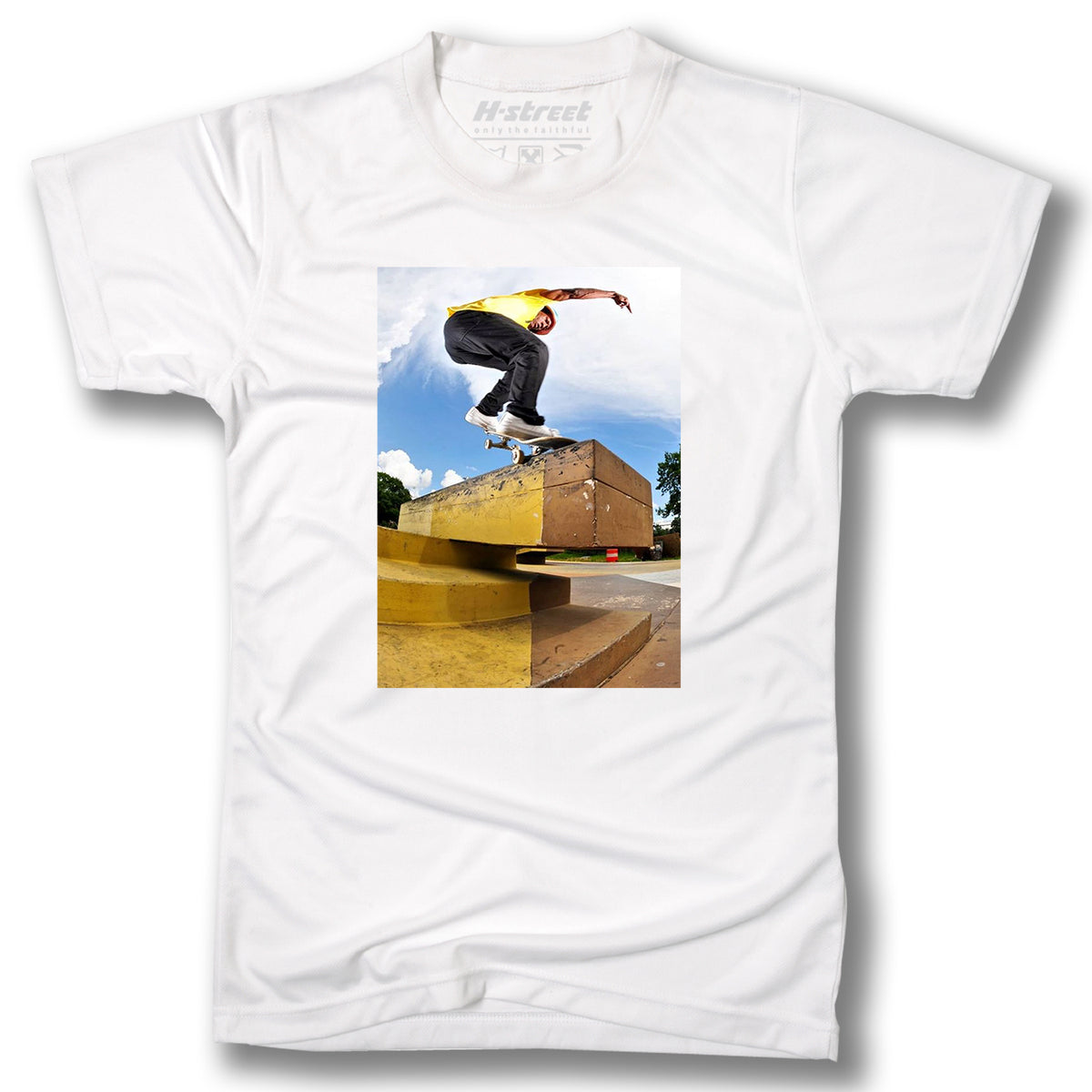 The Minuteman RON ALLEN PHOTO TEE features a digital print of a skateboard trick over a metal ledge with blue sky and clouds—a perfect pick for skateboarding fans.