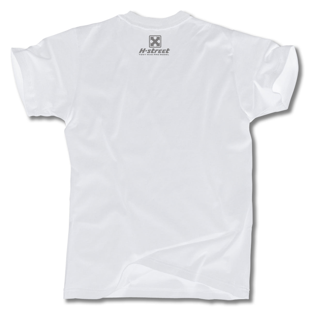 The Minuteman TONY MAG BORN FREE TEE is a plain white short-sleeve shirt shown from the back, with a small gray logo and H-street text near the upper center—paying homage to skateboard art and classic Tony Mag style.