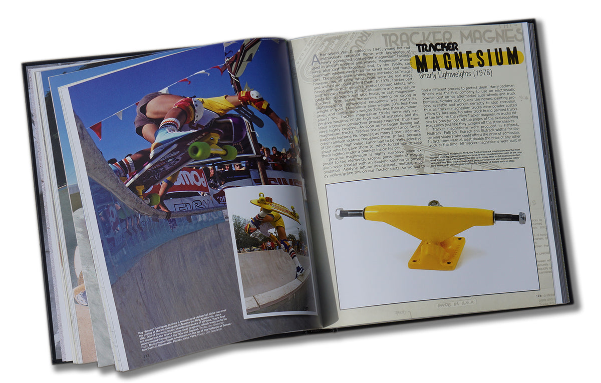 The TRACKER TRUCKS 40TH ANNIVERSARY BOOK by TRACKER shows a skateboarder’s trick in a skatepark on one page and a yellow Tracker Truck with an article about magnesium trucks’ history on the other.