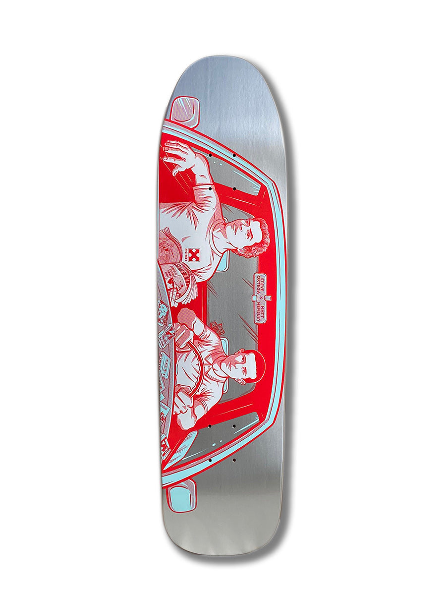 The Woodchuck HENSLEY X ORTEGA VISTA B SERIES skateboard deck showcases a red and blue illustration of two people driving, seen through the windshield, detailed car interior, and metallic silver background honoring Vista street skating roots.